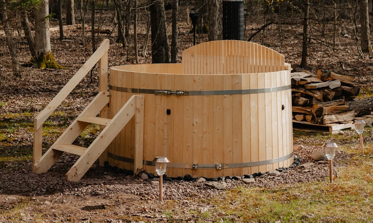 Wooden hot tub in an outdoor setting before removal